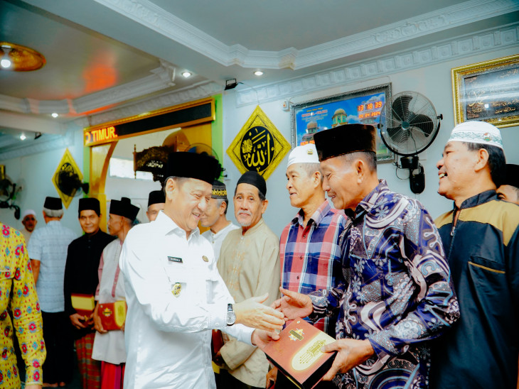 Pj Bupati Kampar Bersama LK2S Berikan Bantuan Mukennah dan Sarung untuk Masyarakat Prasejahtera Salo